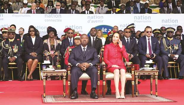 Gabonu2019s President Ali Bongo and his wife Sylvia Bongo attend a parade in Libreville yesterday.
