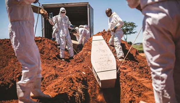 Municipal Johannesburg Morgue workers bury a coffin at the Olifantsvlei Cemetery in Johannesburg.