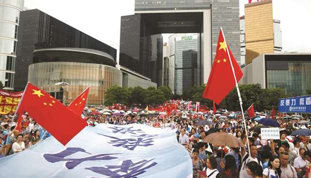 People wave Chinese flags during a pro-China rally at Tamar Park to voice support for the police and call for an end to violence, in Hong Kong yesterday.