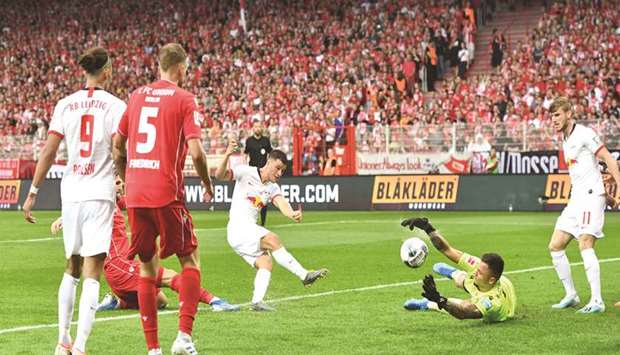 Union Berlin goalkeeper Rafal Gikiewicz (second right) saves a shot from RB Leipzigu2019s Diego Demme during the Bundesliga match in Berlin yesterday. (Reuters)