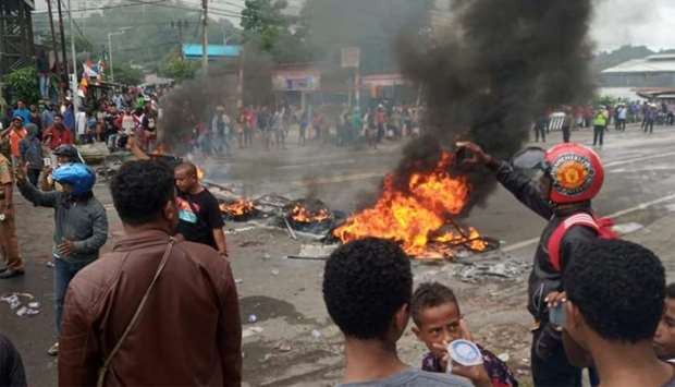People burn tires during a protest at a road in Manokwari, West Papua, Indonesia