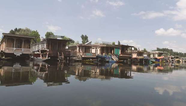 Empty houseboats are seen on Dal Lake in Srinagar yesterday. Authorities yesterday reinstated the heavy restrictions in the city.