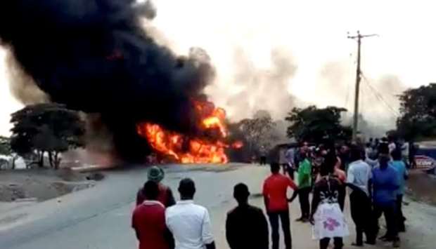 People look towards a fire following a fuel truck collision in Rubirizi, Uganda yesterday in this still image taken from social media video