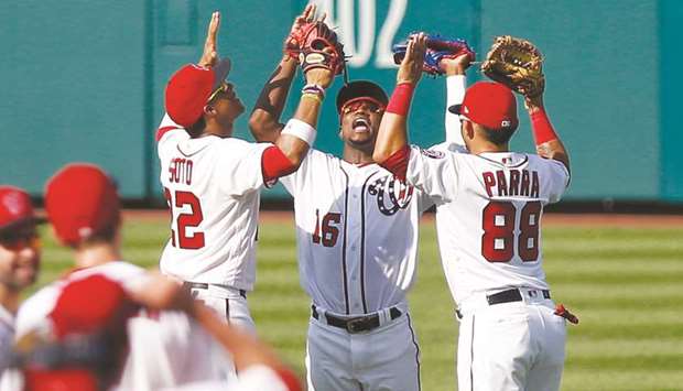 Washington Nationals left fielder Juan Soto (left), Nationals centre fielder Victor Robles (centre) and Nationals centre fielder Gerardo Parra (right) celebrate in the outfield  their victory against the Milwaukee Brewers at Nationals Park. PICTURE: USA TODAY Sports