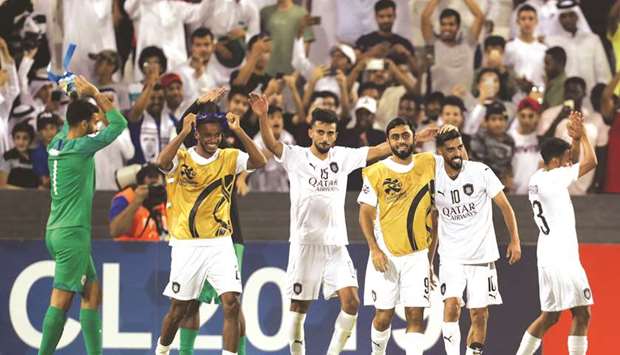 Al Sadd players celebrate after winning the AFC Champions League round of 16 second leg match against Al Duhail at Jassim Bin Hamad stadium last Tuesday. (AFP)