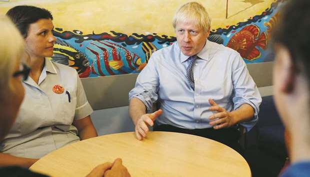 Johnson with health professionals during his visit to the Royal Cornwall Hospital in Truro, Britain.