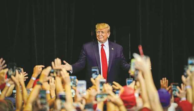 FILE PHOTO: US President Donald Trump greets supports as he arrives at a campaign rally in Cincinnati, Ohio, US.