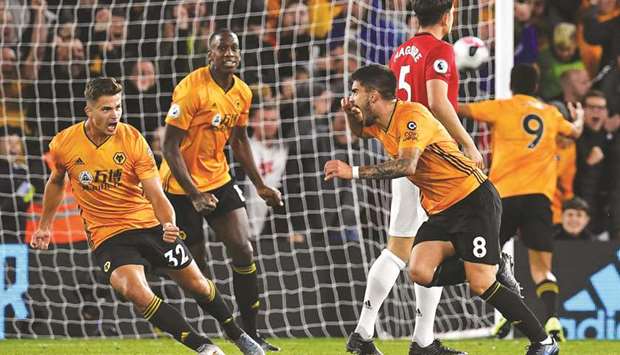 Wolverhampton Wanderersu2019 Ruben Neves (third right) celebrates after scoring against Manchester United during the Premier League match on Monday. (AFP)