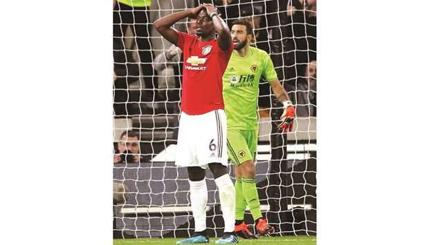 Manchester Unitedu2019s Paul Pogba reacts after his penalty is saved by Wolverhampton  Wanderersu2019 Rui Patricio (right) during the Premier League match. (Reuters)