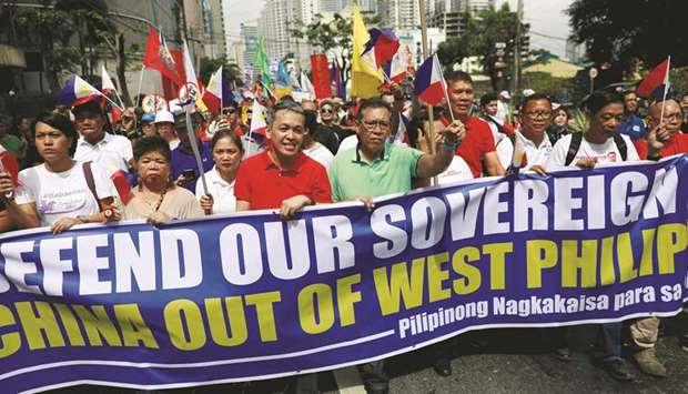 File photo taken on April 9, shows Filipino activists and opposition leaders marching to protest the presence of Chinese vessels in South China Sea at the Chinese Embassy in Makati City.