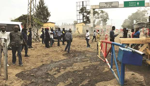 Congolese customs agents gather at the gate barriers at the border crossing point with Rwanda following its closure over Ebola threat in Goma, eastern Democratic Republic of Congo, yesterday.
