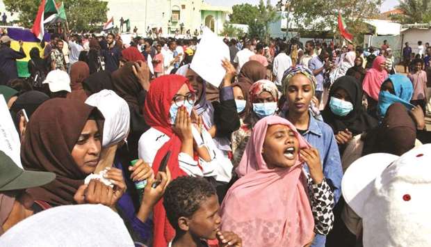 Sudanese protesters chant slogans during demonstration in Khartoum yesterday.