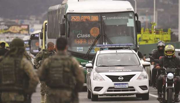 The bus in which a gunman held 31 hostages before being shot dead by police is being taken away, in Rio de Janeiro, Brazil, yesterday.