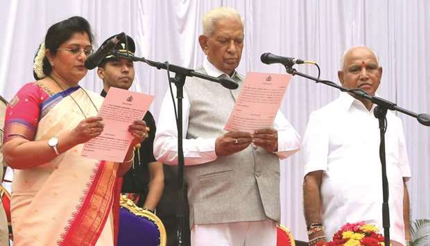 Karnataka Governor Vajubhai Vala administers the oath of office to Jolle Sashikala Annasaheb in Bengaluru yesterday.
