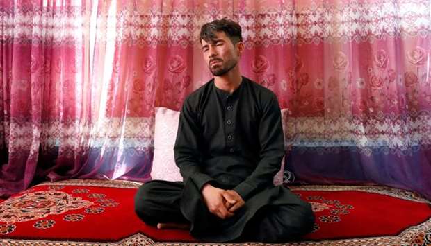 Mirwais Elmi 26, an Afghan groom who survived a suicide attack at his wedding reception on Saturday night, reacts during an interview at his house in Kabul