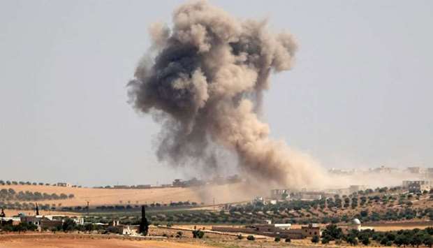 Smoke billows during pro-regime bombardments in the area of Maar Hitat in Syria's northern Idlib province