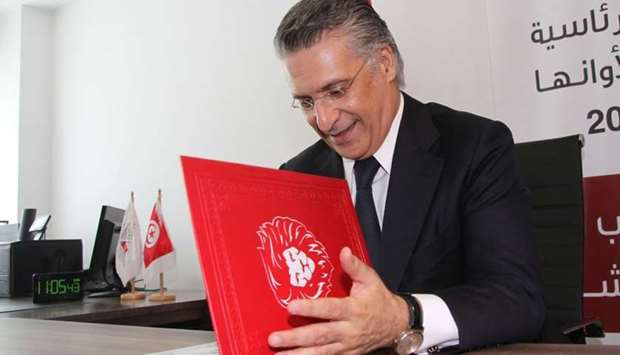 Nabil Karoui, Tunisian media magnate and would-be presidential candidate submits his candidacy to Tunisia's electoral commission in the capital Tunis