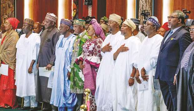 Members of Nigeriau2019s new cabinet take an oath of office during a swearing-in ceremony in Abuja yesterday.