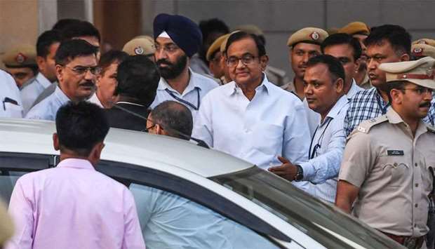 Ex-finance minister Palaniappan Chidambaram (C in white shirt with glasses) leaves a court in New Delhi 