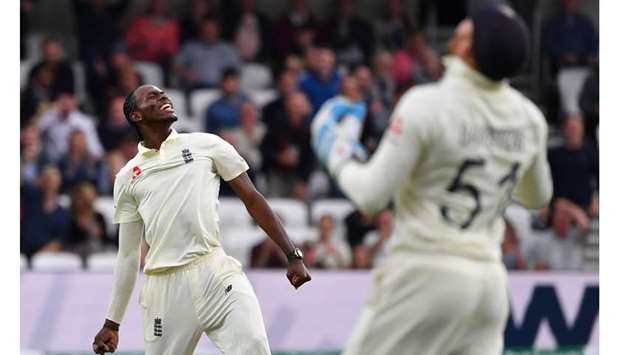 Englandu2019s Jofra Archer (left) celebrates taking the wicket of Australiau2019s Pat Cummins (not pictured) on the first day of the third Ashes Test at Headingley in Leeds, United Kingdom, yesterday. (AFP)