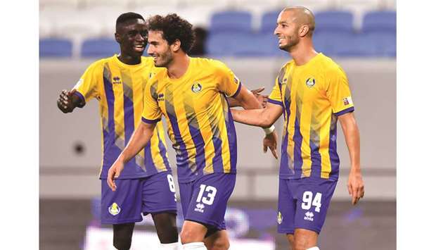 Al Gharafau2019s Ahmed Alaaeldin (centre) celebrates his goal with teammate Sofiane Hanni (right) during their match against Al Shahania yesterday. PICTURE: Noushad Thekkayil