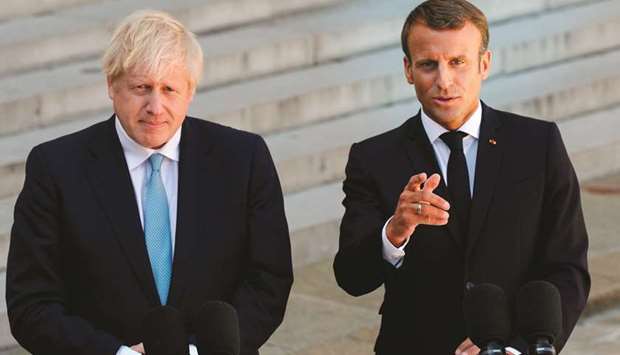 French President Emmanuel Macron and Britainu2019s Prime Minister Boris Johnson address a press conference at The Elysee Palace yesterday.