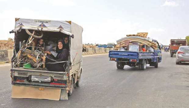 Syrians fleeing from Maaret al-Numan and its surrounding countryside drive with their belongings northwards near the town of Saraqib in Idlib province yesterday.