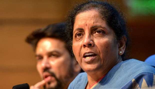 Union Finance Minister Nirmala Sitharaman (R) speaks as she attends a press conference along with Member of Parliament (MP) Anurag Thakur and Finance Secretary Rajiv Kumar in New Delhi
