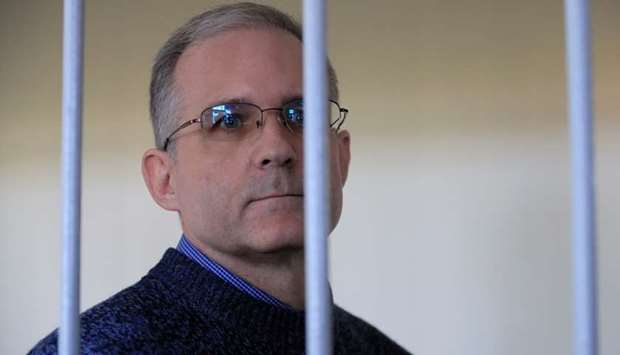 Former US Marine Paul Whelan, who was detained and accused of espionage, looks out of a defendants' cage before a court hearing in Moscow, Russia August 23