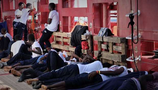 Rescued migrants rest aboard the Ocean Viking, run by French charities Medecins Sans Frontieres and SOS Mediterranee, as it waits in international waters between Malta and the southern Italian island of Linosa