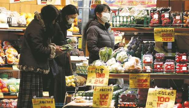 Women look at price tags for packed vegetables at a supermarket at Shibuya shopping district in Tokyo. Japanu2019s core consumer price index, which includes oil products but excludes fresh food prices, rose 0.6% in July year-on-year, matching economistsu2019 median estimate.