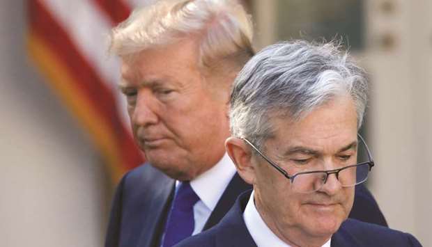 US President Donald Trump looks on as Fed chair Jerome Powell moves to the podium at the White House in Washington DC (file). The Fed chair, under pressure from Trump and markets to cut rates, characterised the US economy as in a u201cfavourable placeu201d but facing u201csignificantu201d risks, especially what Fed officials have described as the harmful effects of the White Houseu2019s trade war with China.