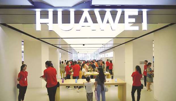 People visit a newly opened Huawei store in Xian, Shaanxi province. Huaweiu2019s $100bn business has been hit hard since mid-May after Washington put the worldu2019s second-largest smartphone maker in a so-called Entity List that threatens to cut off its access to essential US components and technology.