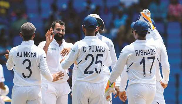 Mohamed Shami (second from left) of India celebrates the dismissal of John Campbell (not pictured) of West Indies on the second day of the first Test in North Sound, Antigua and Barbuda, yesterday. (AFP)