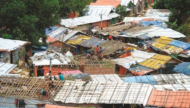 Rohingya refugees renovate makeshift houses at Kutupalong refugee camp in Ukhia district yesterday.