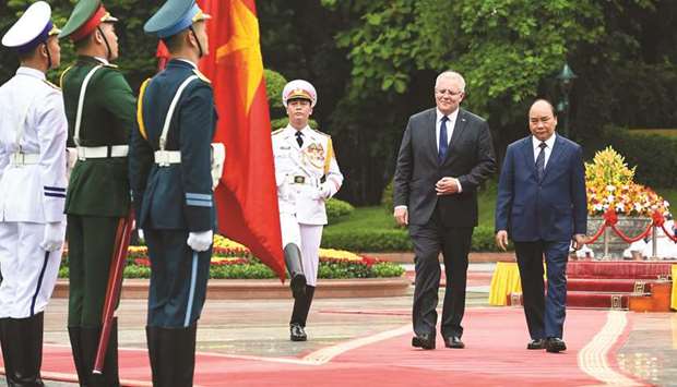Australiau2019s Prime Minister Scott Morrison, left, inspects a guard of honour with his Vietnamese counterpart Nguyen Xuan Phuc during a welcoming ceremony at the Presidential Palace in Hanoi yesterday.