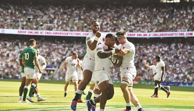 Englandu2019s Manu Tuilagi (centre) celebrates scoring a try with teammates Tom Curry (right) and Joe Cokanasiga (left) during the international Test rugby union match against Ireland at Twickenham yesterday. (AFP)