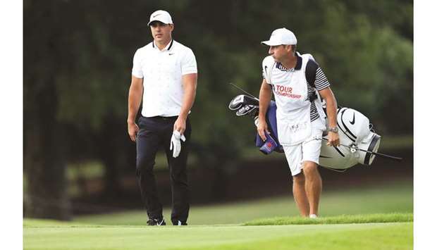 Brooks Koepka of the United States and caddie Ricky Elliott walk to the 17th tee during the second round of the Tour Championship at East Lake Golf Club in Atlanta.