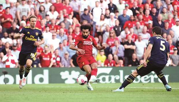 Liverpoolu2019s Mohamed Salah (left) scores against Arsenal during the Premier League match at Anfield. (Reuters)