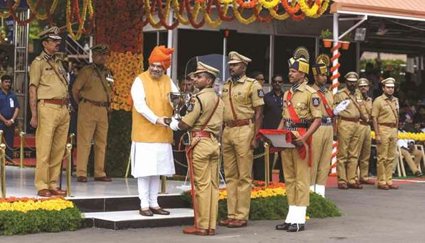 Home Minister Amit Shah presents a trophy to Indian Police Service (IPS) probationers as they take part in an academic passing out parade at Sardar Vallabhbhai Patel National Police Academy in Hyderabad yesterday.
