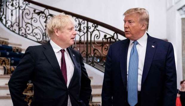 US President Donald Trump (R) and Britain's Prime Minister Boris Johnson speak before a working breakfast at the G7 Summit in Biarritz, France