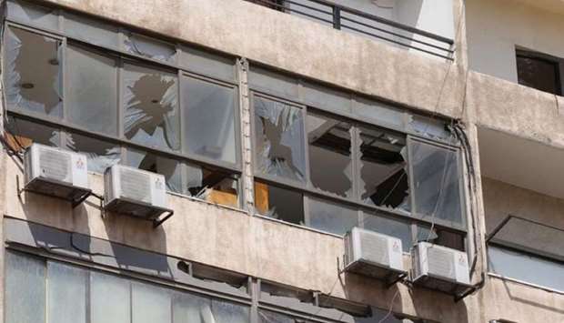 Broken windows are pictured after an Israeli drone fell in the Hezbollah-dominated southern suburbs and a second one exploded near the ground in Dahiyeh suburbs of Beirut