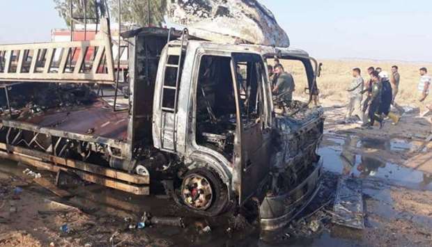 A handout picture released by the Hashed al-Shaabi force shows the wreckage of a vehicle at the site of an unclaimed drone attack near Iraq's western border with Syria