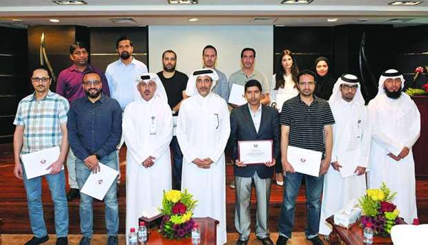 HE the Minister of Culture and Sports, Saleh bin Ghanem bin Nasser al-Ali, with the staff of the Information Systems Department who were honoured at the event.