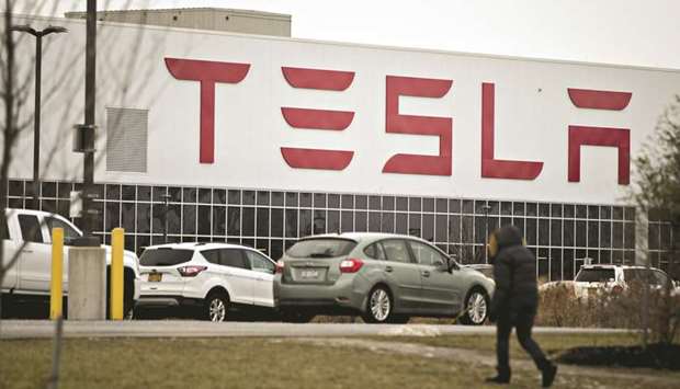 A man walks outside the Tesla solar panel factory in Buffalo, New York. News of the Amazon fire comes just three days after Walmart dropped a bombshell lawsuit against Tesla, accusing it of shoddy panel installations that led to fires at more than a half-dozen stores.