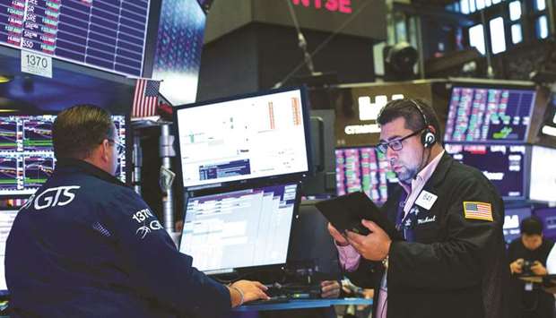 Traders work on the floor of the New York Stock Exchange (file). More investors are watching the shares of discount retailers like Dollar General and Dollar Tree, which perform better during economic downturns, in the hopes of gauging changes in consumer behaviour, though higher tariffs may erode the companiesu2019 ability to act as economic bellwethers.