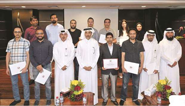 HE the Minister of Culture and Sports, Salah bin Ghanem bin Nasser al-Ali, with the staff of the Information Systems Department who were honoured.