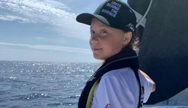Greta Thunberg stands on the bow of the Mazilia II racing yacht as she completes half of her trans-Atlantic crossing at sea on August 20, 2019