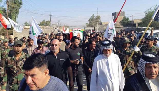 Iraqis and members of the Hashed (Popular Mobilisation units) taking part in the funeral procession of their comrade Kazem Mohsen, known by his nom de guerre Abu Ali al-Dabi, near the capital Baghdad