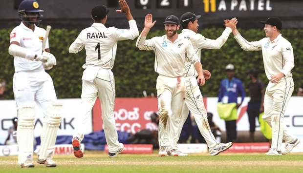 New Zealand captain Kane Williamson (C) celebrates with his teammates after winning the second Test in Colombo yesterday.